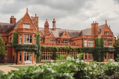 Historic ivy-clad red brick Victorian manor in England.