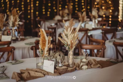 Rustic wedding table decor with pampas grass centerpiece.