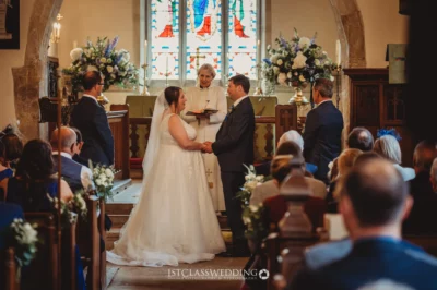 Couple exchanging vows in church wedding ceremony.