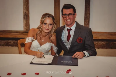 Bride and groom signing wedding register.