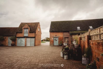 Rustic brick buildings with courtyard in English countryside.