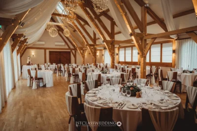 Elegant barn wedding reception venue with festive lights.