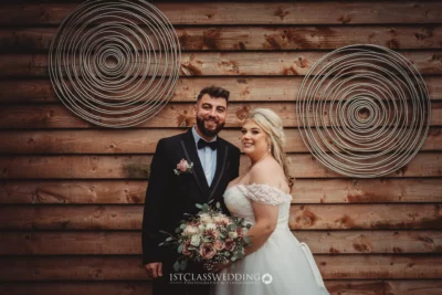 Wedding couple portrait with rustic wooden background.