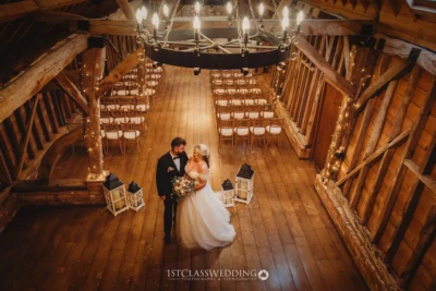 Couple in rustic barn wedding venue.