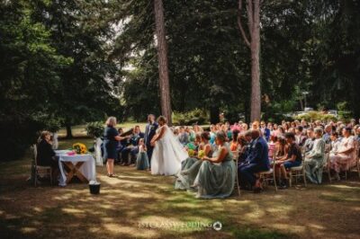 Outdoor wedding ceremony in forest clearing.
