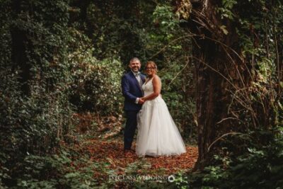 Couple posing in forest at their wedding day.