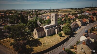 Aerial view of British village with historic church.