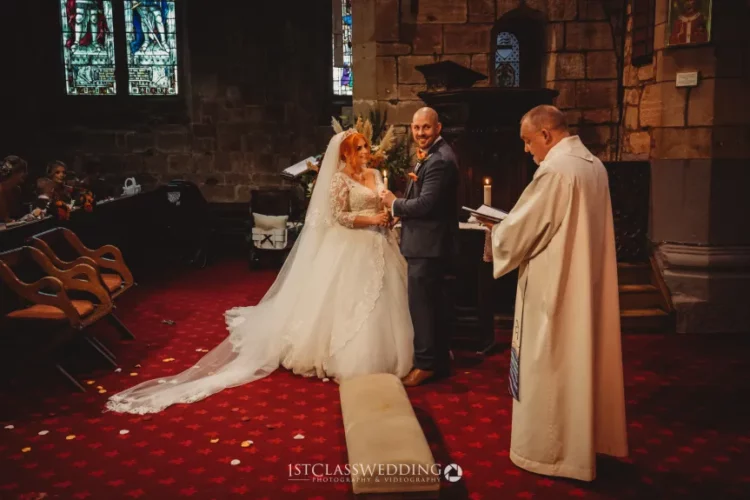 Couple exchanging vows at church wedding ceremony.