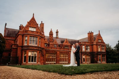 Couple at historic manor house wedding venue.