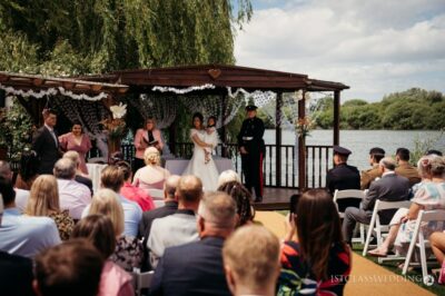 Outdoor wedding ceremony by a lake.