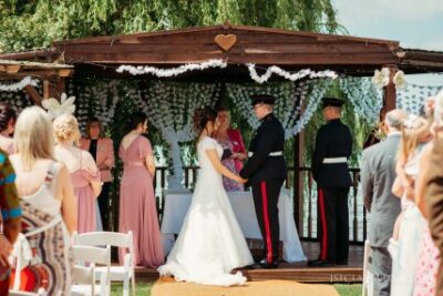 Outdoor wedding ceremony with military groom.