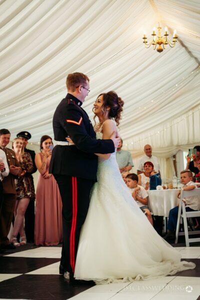 Bride and groom sharing first dance at wedding.