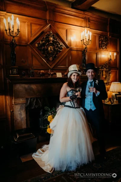 Couple celebrating in vintage wedding attire with champagne.