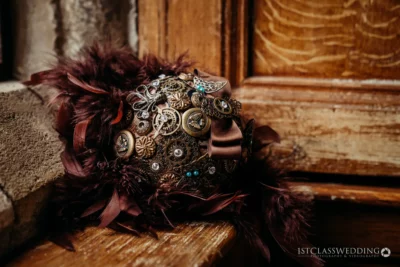 Steampunk-inspired feathered bouquet on wooden backdrop.