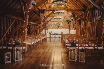 Rustic barn wedding venue interior with fairy lights.
