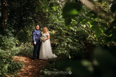 Bridal couple in wooded area.