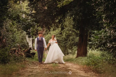 Bride and groom walking in forest setting