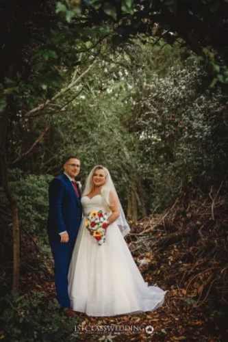 Couple posing in forest wedding photo shoot.