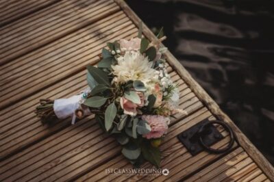 Bridal bouquet on wooden surface with rustic style