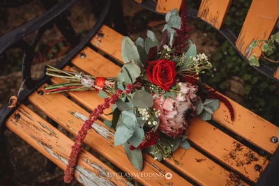 Wedding bouquet on rustic bench.
