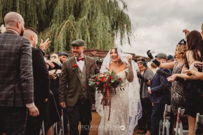 Wedding couple confetti celebration with guests outdoors