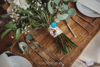 Wedding bouquet on wooden table with cutlery