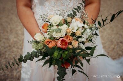 Bride holding vibrant wedding bouquet.