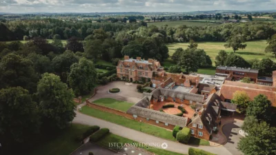 Aerial view of a stately countryside manor in the UK.
