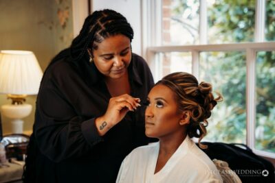 Bridal makeup artist at work on a client.