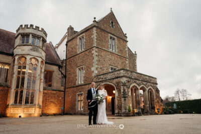 Bride and groom outside historic UK castle venue.