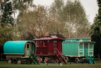 Traditional caravans in lush green park.