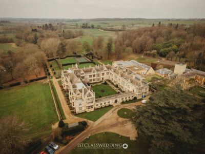 Aerial view of historic country mansion Rushton Hall and landscaped gardens.
