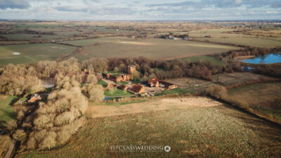 Aerial view of countryside estate with historic building in UK.