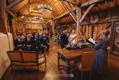 Wedding ceremony in rustic barn venue.