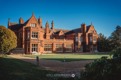 Elegant historic British manor house on sunny day.