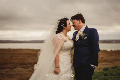 Bride and groom sharing a moment in scenic landscape
