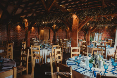 Rustic wedding venue setup with blue table decor.