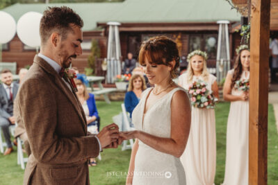 Outdoor wedding ring exchange ceremony moment