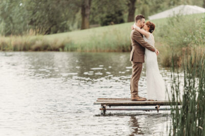 Couple kissing on jetty by lake