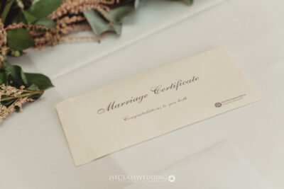 Elegant marriage certificate with calligraphy and foliage.
