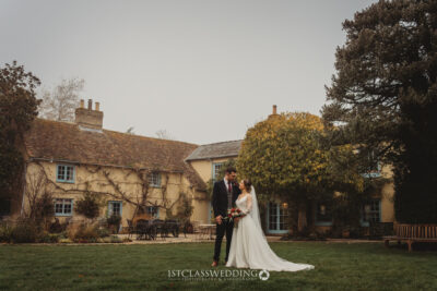Bride and groom outside historic countryside manor.