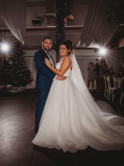 Couple's first dance at wedding with illuminated initials.