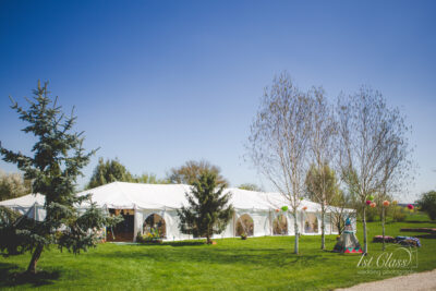 Marquee tent at outdoor wedding venue in sunny weather