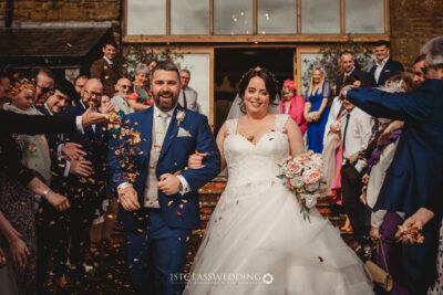 Bride and groom with confetti at wedding celebration at Crockwell Farm.