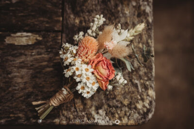 Rustic wedding bouquet on wooden surface.