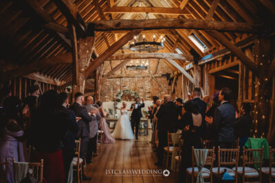 Wedding ceremony in rustic barn venue.