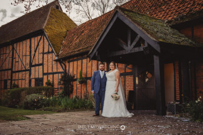 Couple at traditional British wedding venue at Kingfisher Tithe Barn Wedding Venue Bedford.