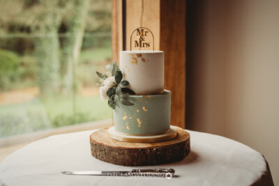 Elegant two-tier wedding cake with 'Mr & Mrs' topper.