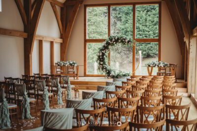 Rustic wedding venue interior with floral decorations.
