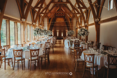 Elegant barn wedding venue with decorated tables.
